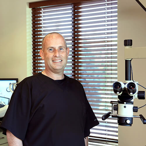 Marshall T. Lavin with an endodontic microsope